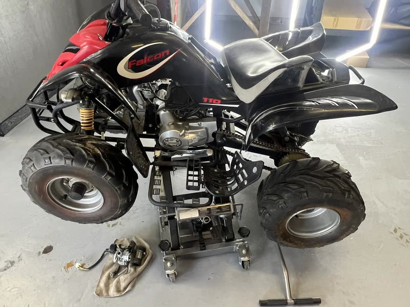 ATV up on a lift in the service bay