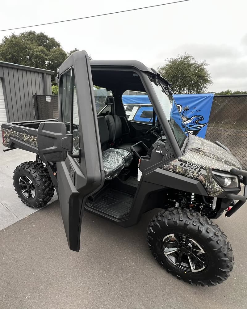 Camo Bighorn UTV with a full cab and dump bed