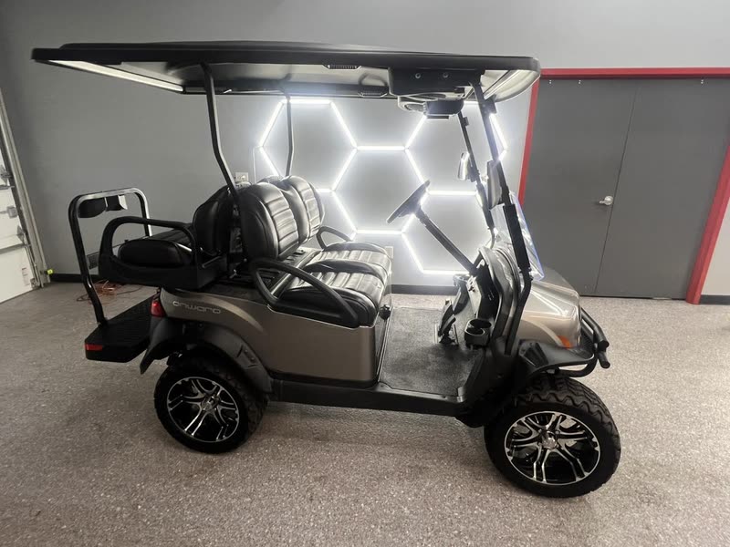 Club Car Onward golf cart under the hexagon lights in the shop