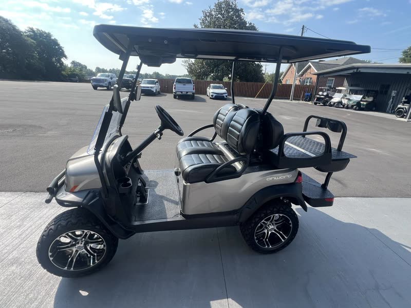 Lifted metallic gray Club Car Onward golf cart with premium wheels