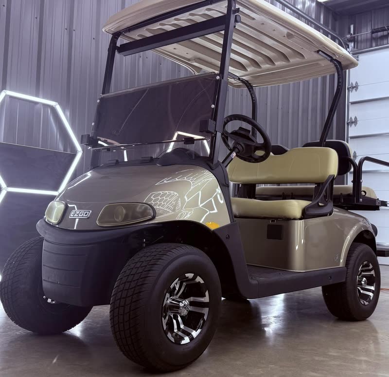 E-Z-GO RXV gas golf cart parked outside the shop