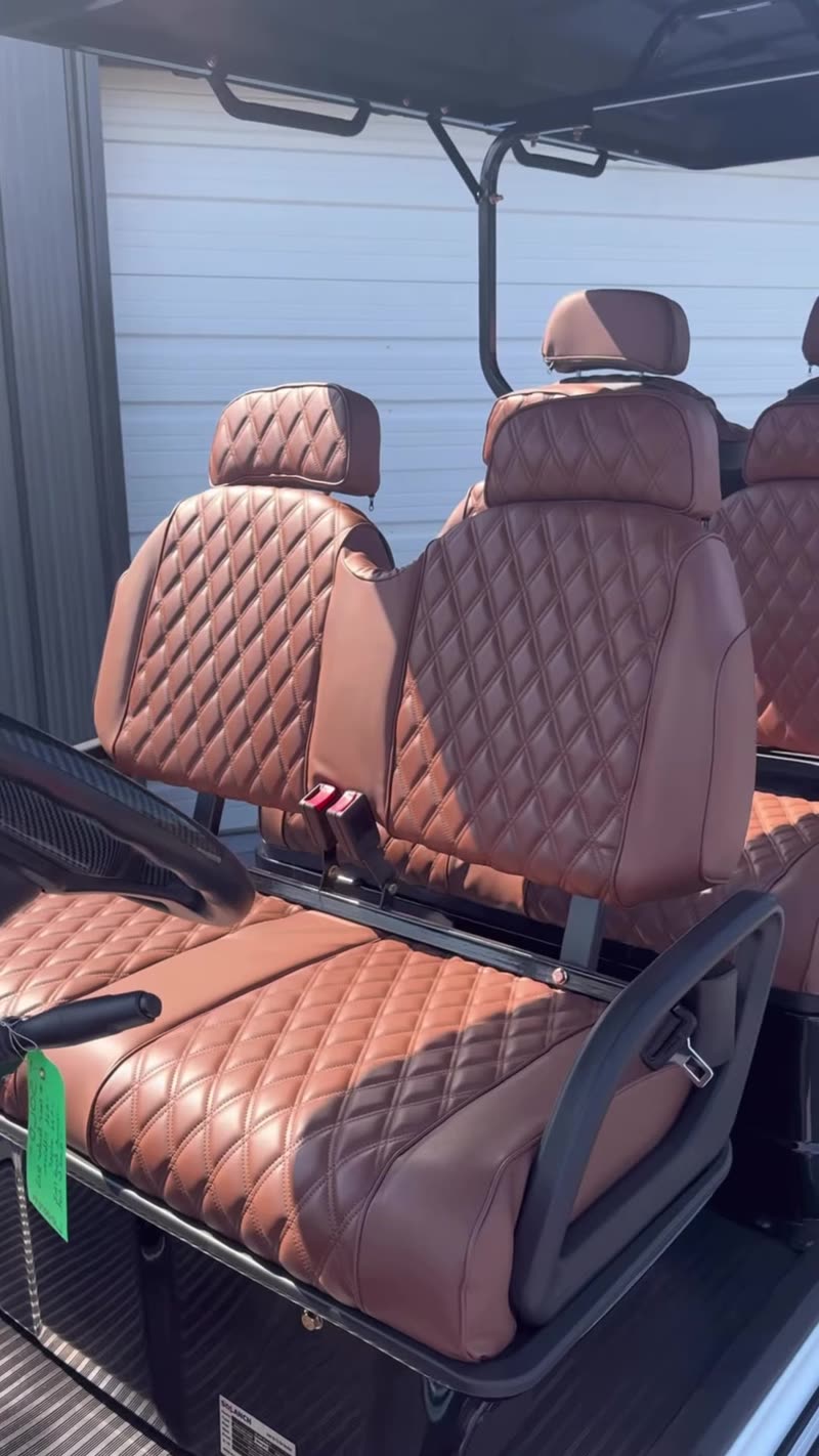 Diamond-stitched brown seats on a six-passenger Glyde G6 golf cart