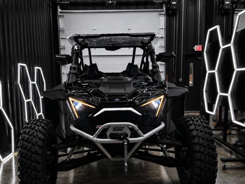 Polaris RZR with its LED headlights on, framed by hexagon lights